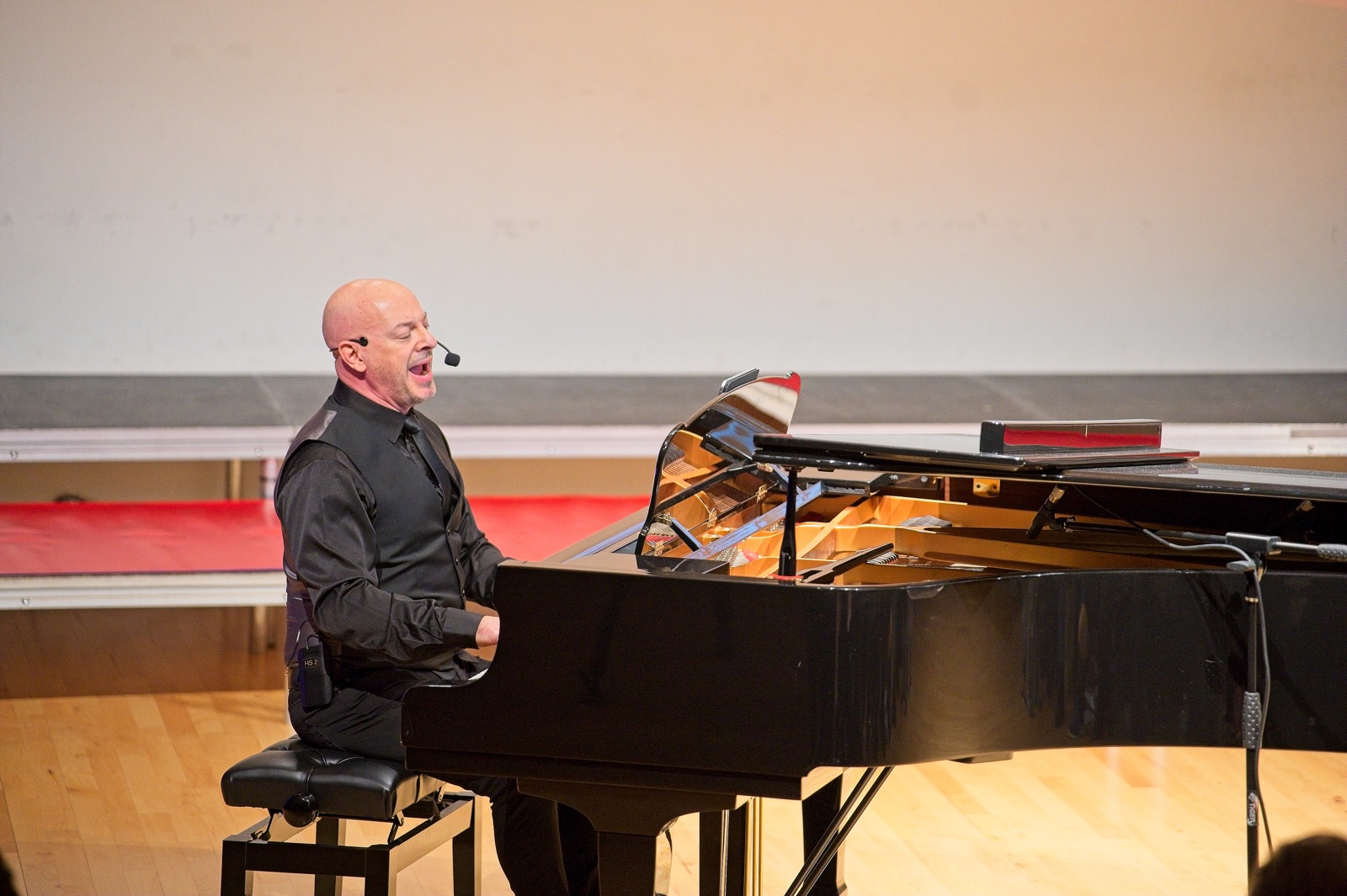 A workshop leader at the grand piano during World Voices Festival